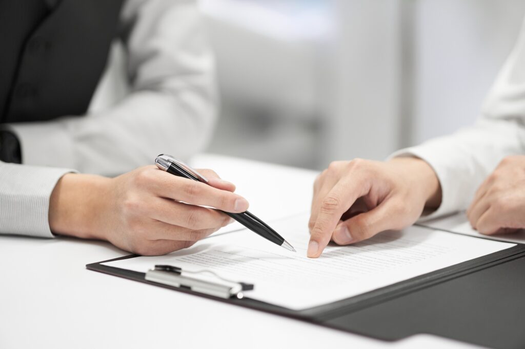 A Japanese male businessman checks the contents of a contract